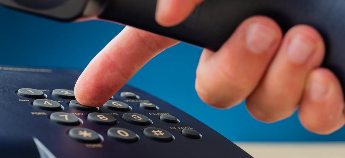 male hand holding telephone receiver dialing phone 2023 11 27 05 24 26 utc 1